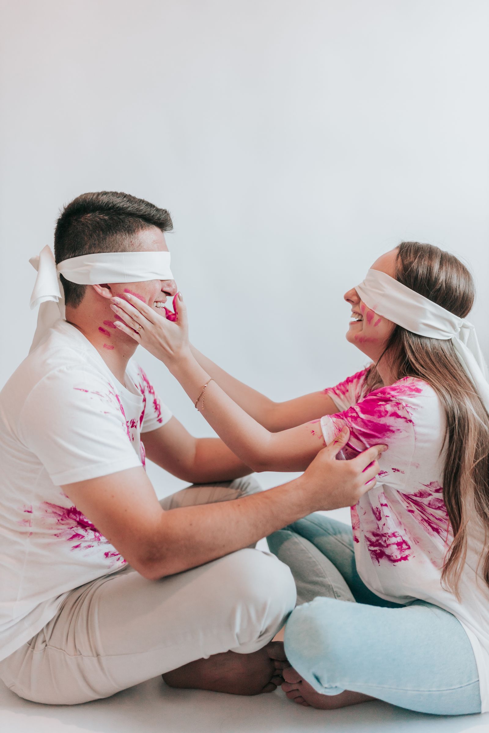 Smiling couple wearing blindfolds for a guessing game