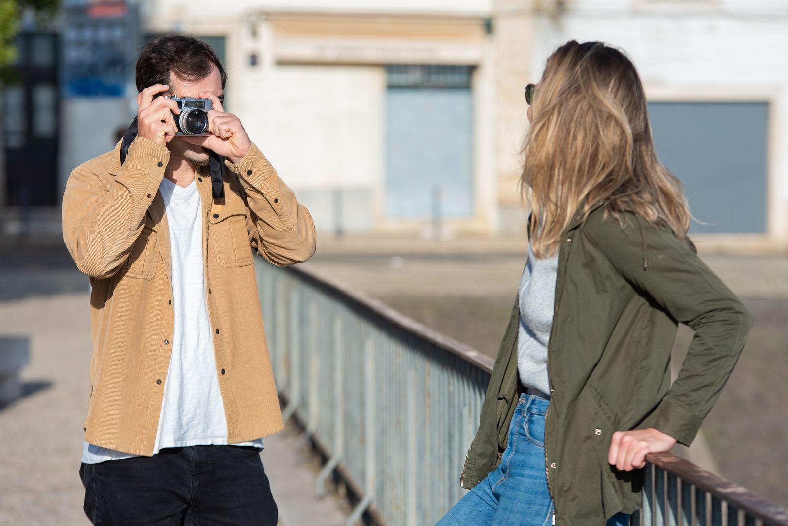 Person photographing their partner during an outdoor activity
