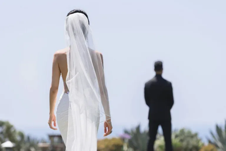 Bride walking outdoors toward a distant person, symbolizing transition, commitment, and a major life step